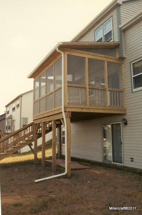 Elevated porch and stairs on a beige townhouse exterior in a residential neighborhood