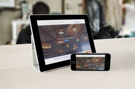 A tablet and a cell phone are sitting on a table.