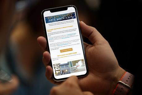 A person is holding a cell phone in their hand.