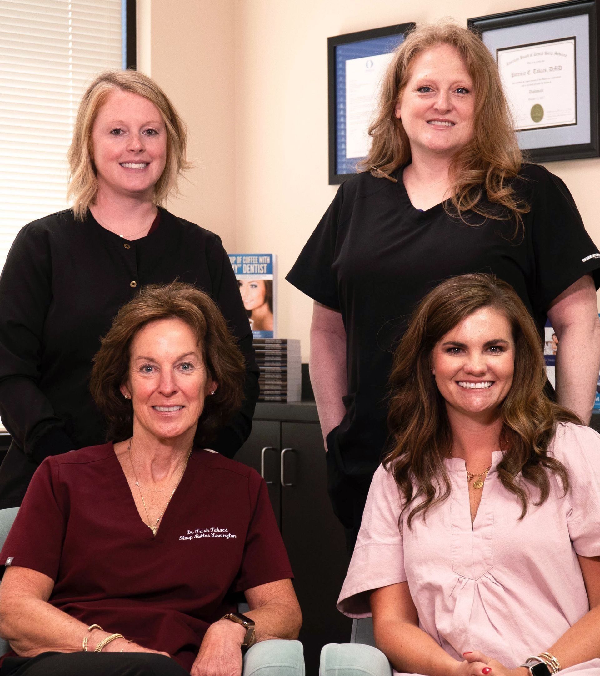 A group of women are posing for a picture in a room.
