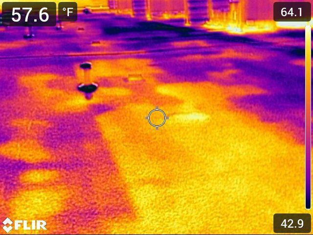 Thermal image showing a surface with varying temperatures, represented by yellow and purple hues