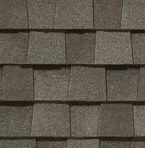Close-up of brown asphalt roof shingles with a textured surface.