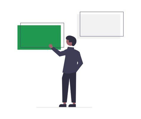 Man points at a green rectangle on a wall, another blank rectangle above.