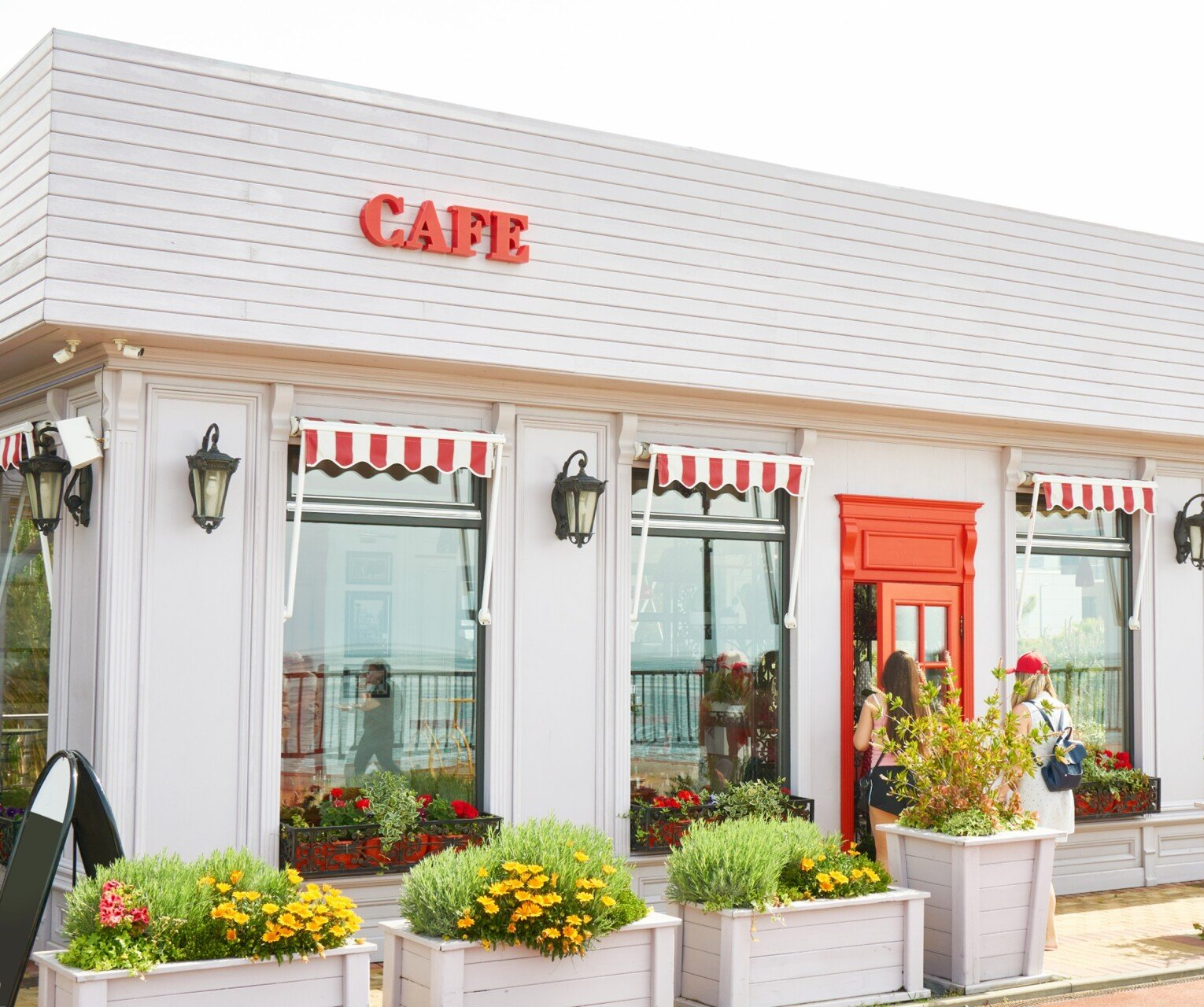 Cafe with red door, awning, and