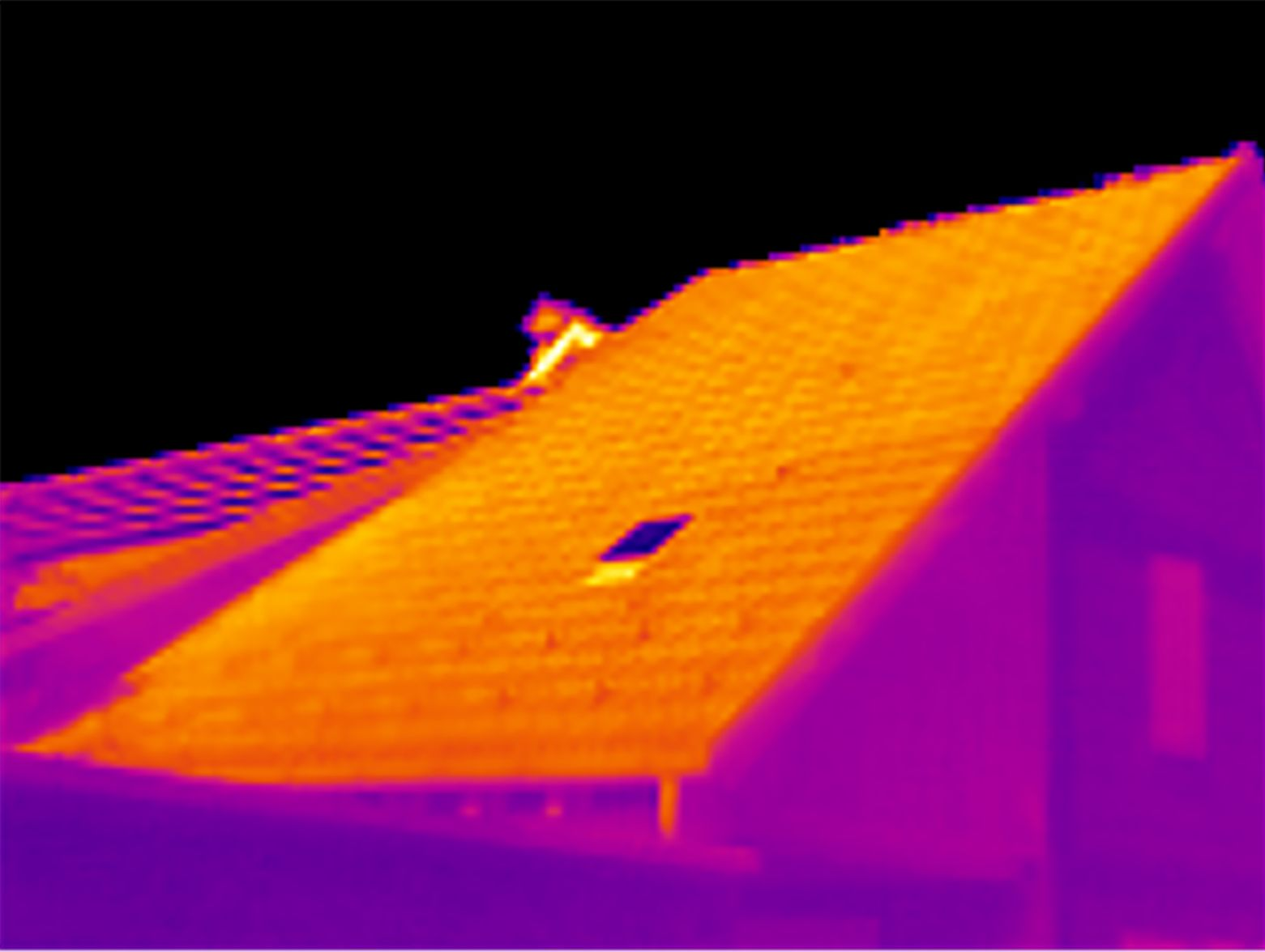 Thermal image of a house roof, showing heat loss around a skylight.