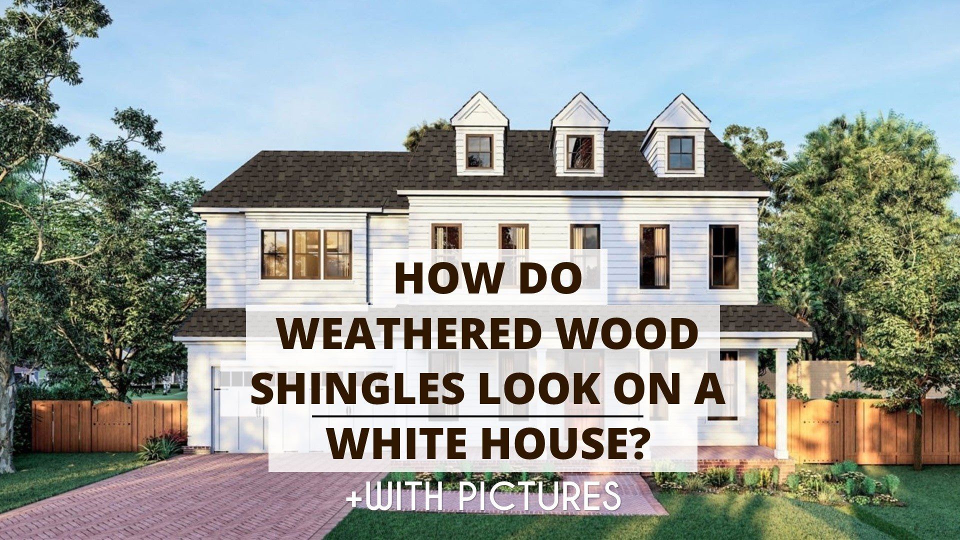 White house with weathered wood shingles, three dormers, and a brick driveway.