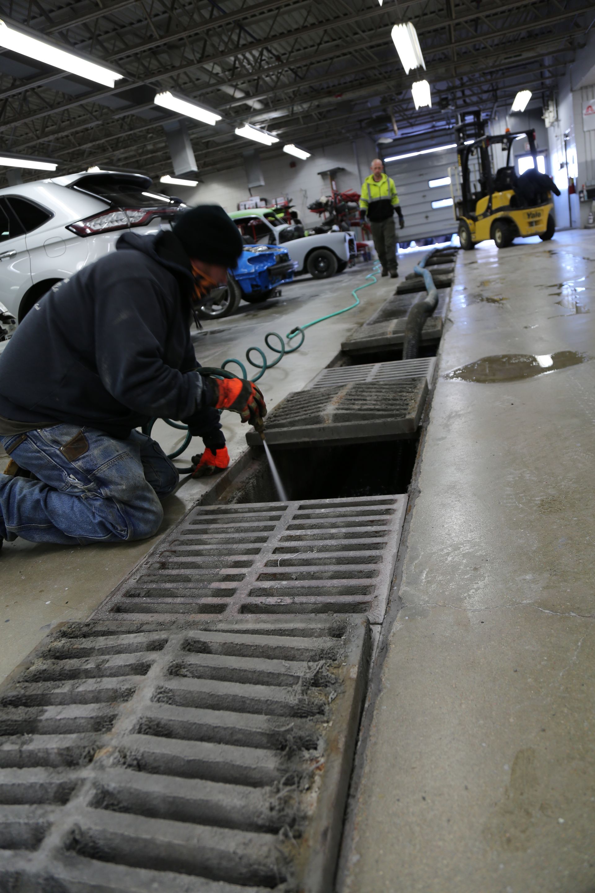 A technician cleans out a commercial mudpit.