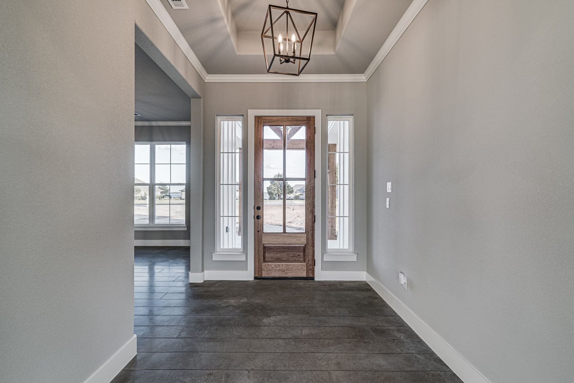 home entryway with chandelier and front door