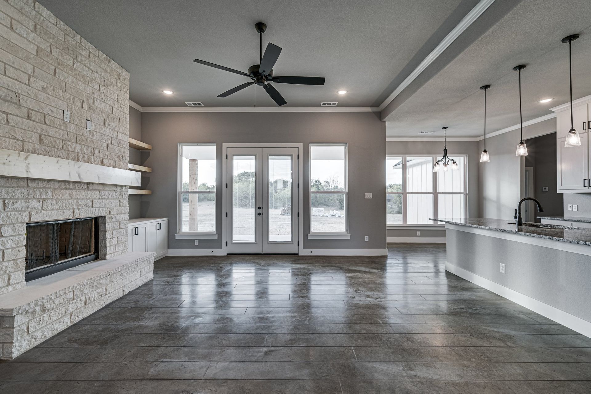 open living space with fireplace and large windows