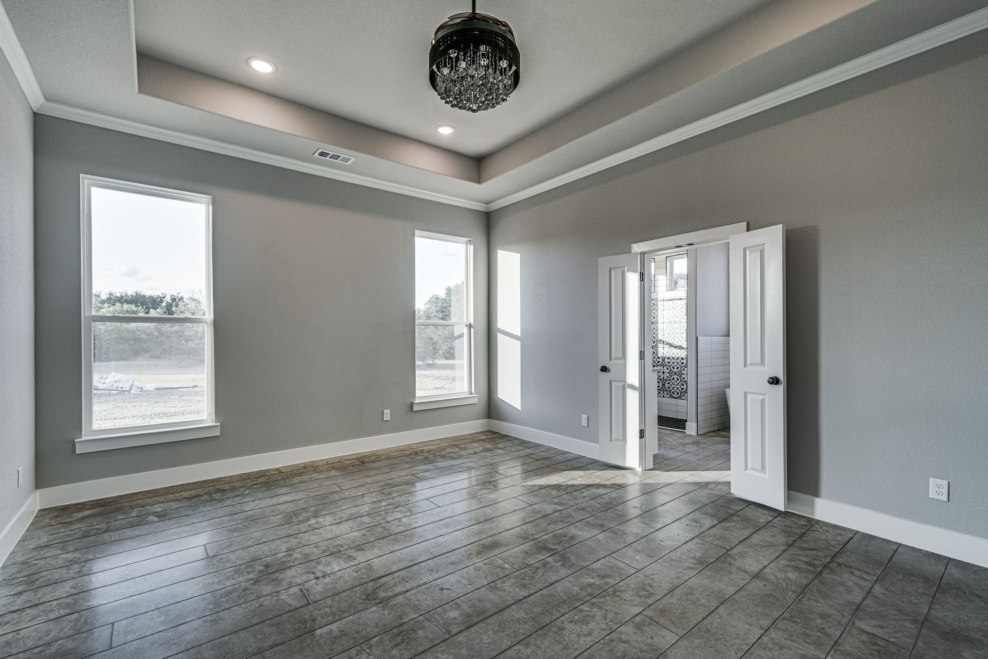 bedroom with tray ceiling and modern finishes