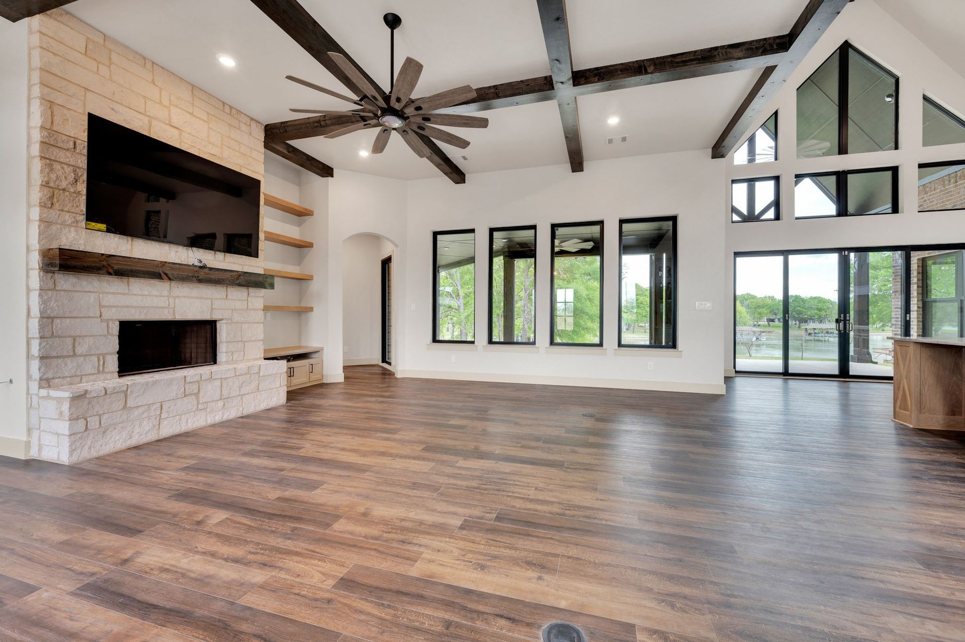 living room with vaulted ceilings and stone fireplace