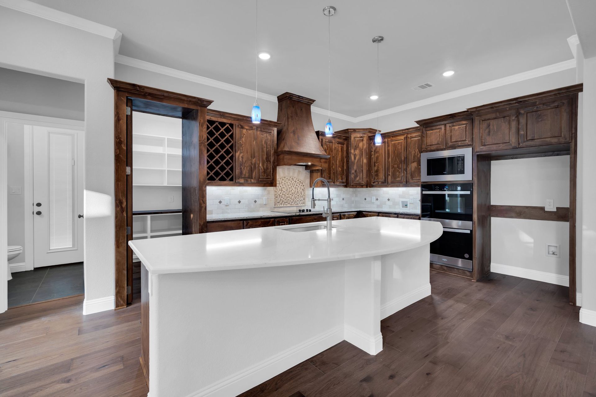 custom kitchen with large island and wood cabinetry