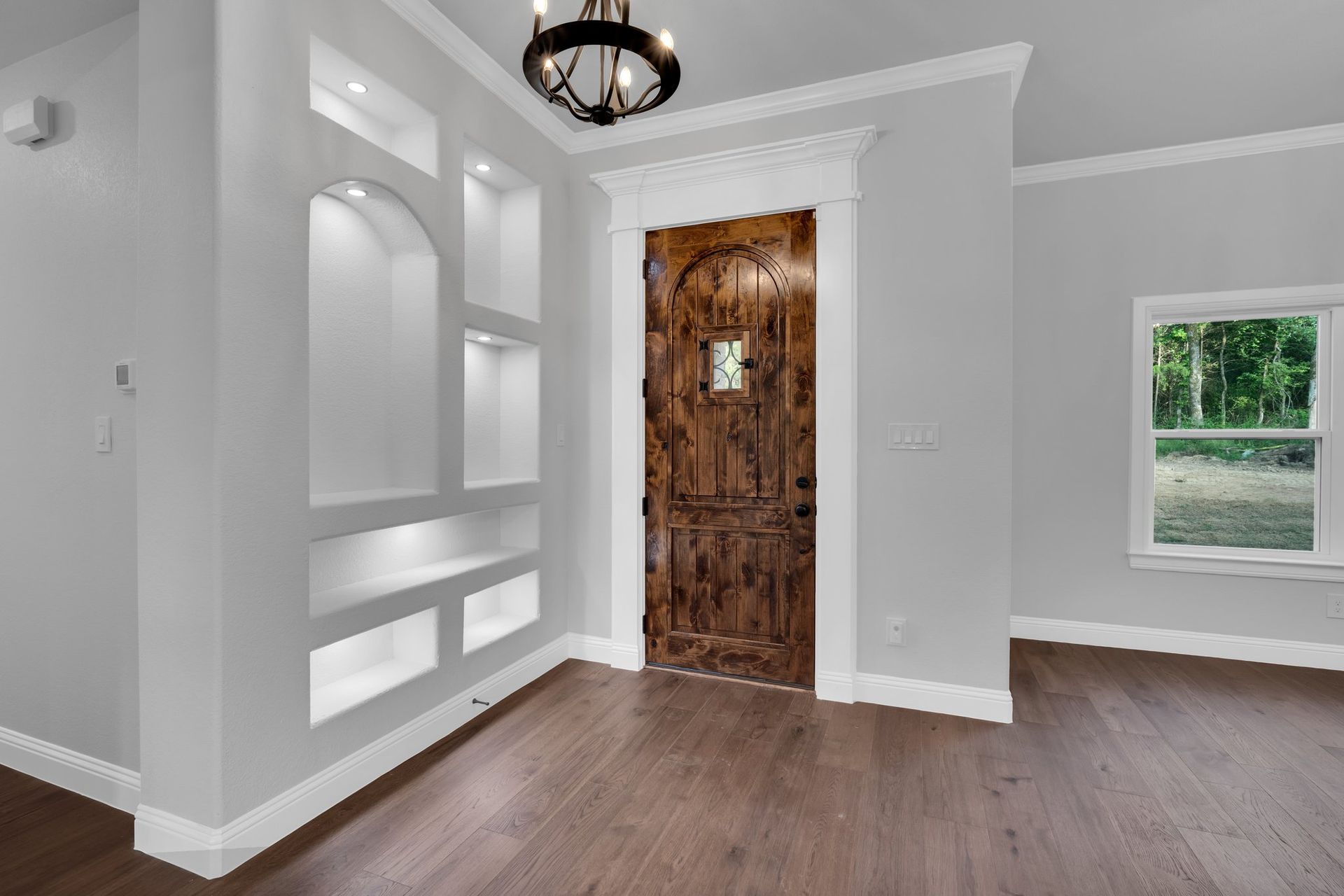 home entryway with custom wood front door