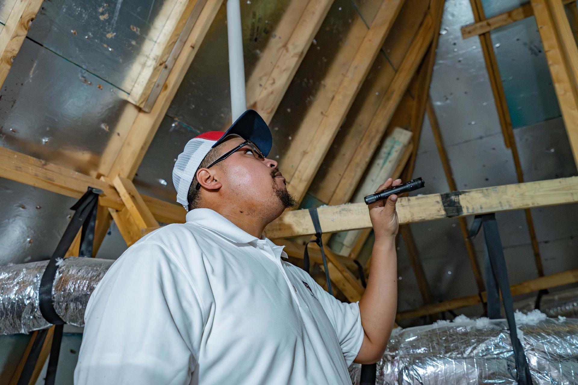 contractor inspecting home insulation and framing