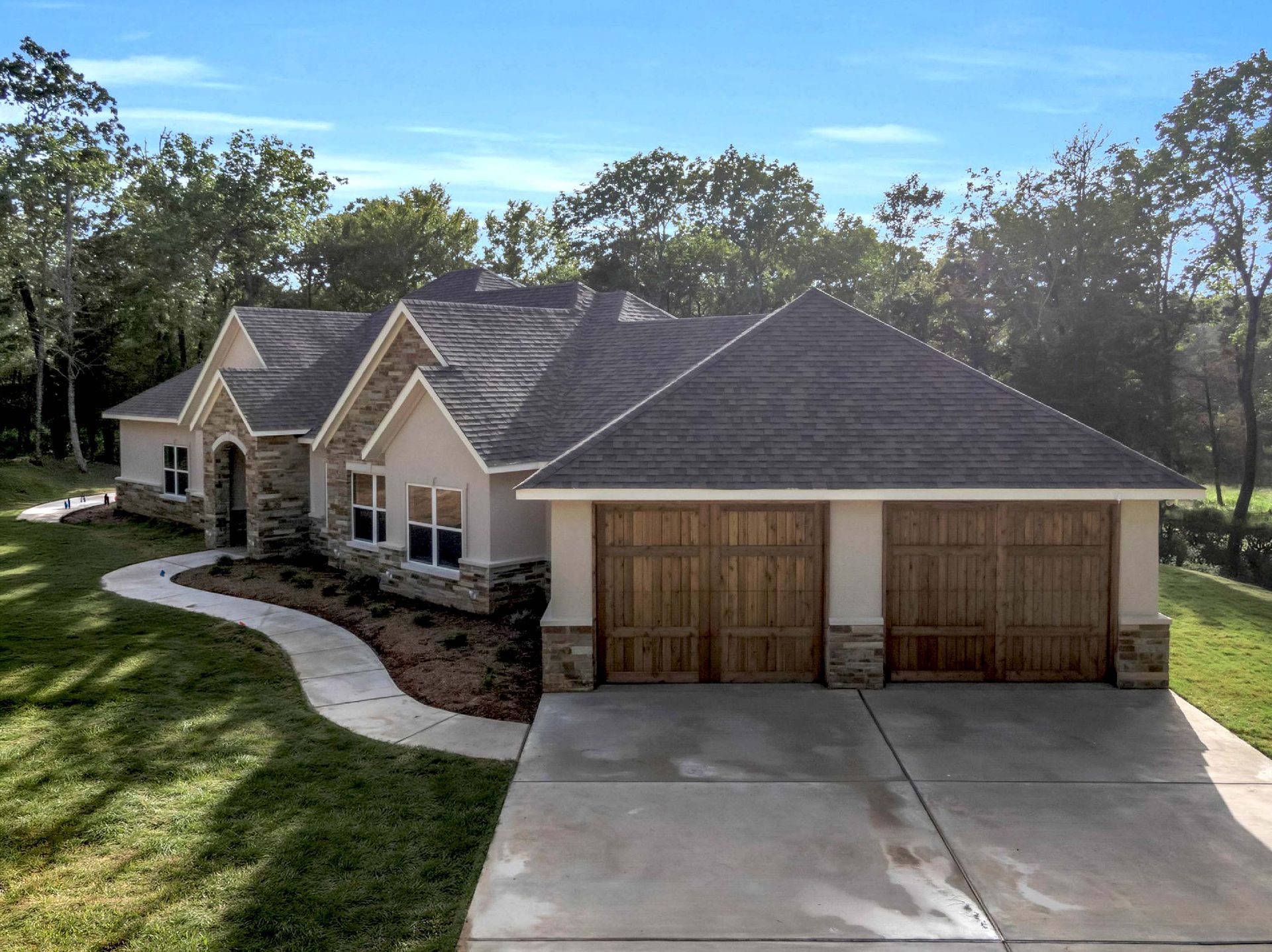 custom home exterior with three-car garage in DFW