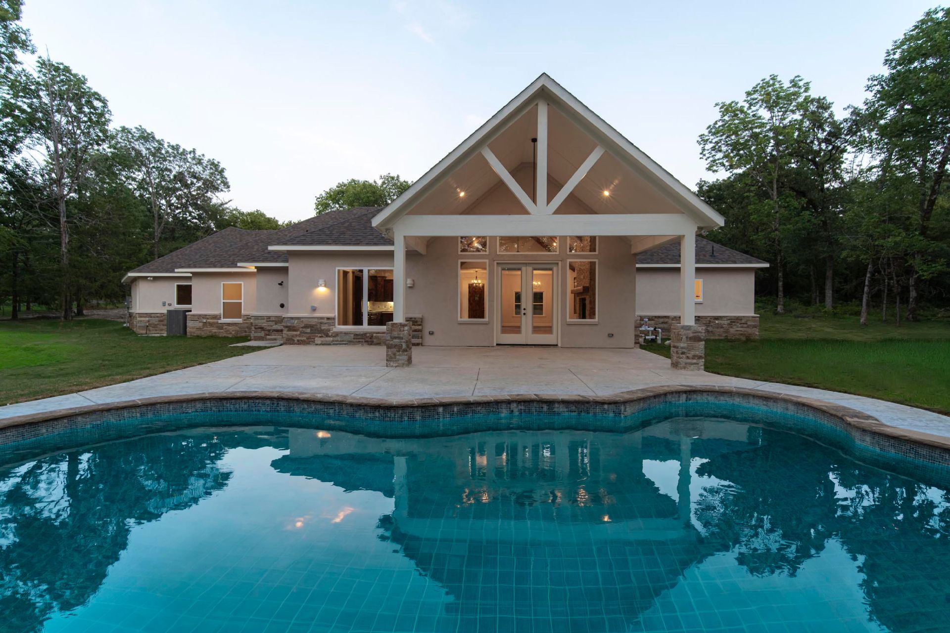 custom home with backyard pool and covered patio