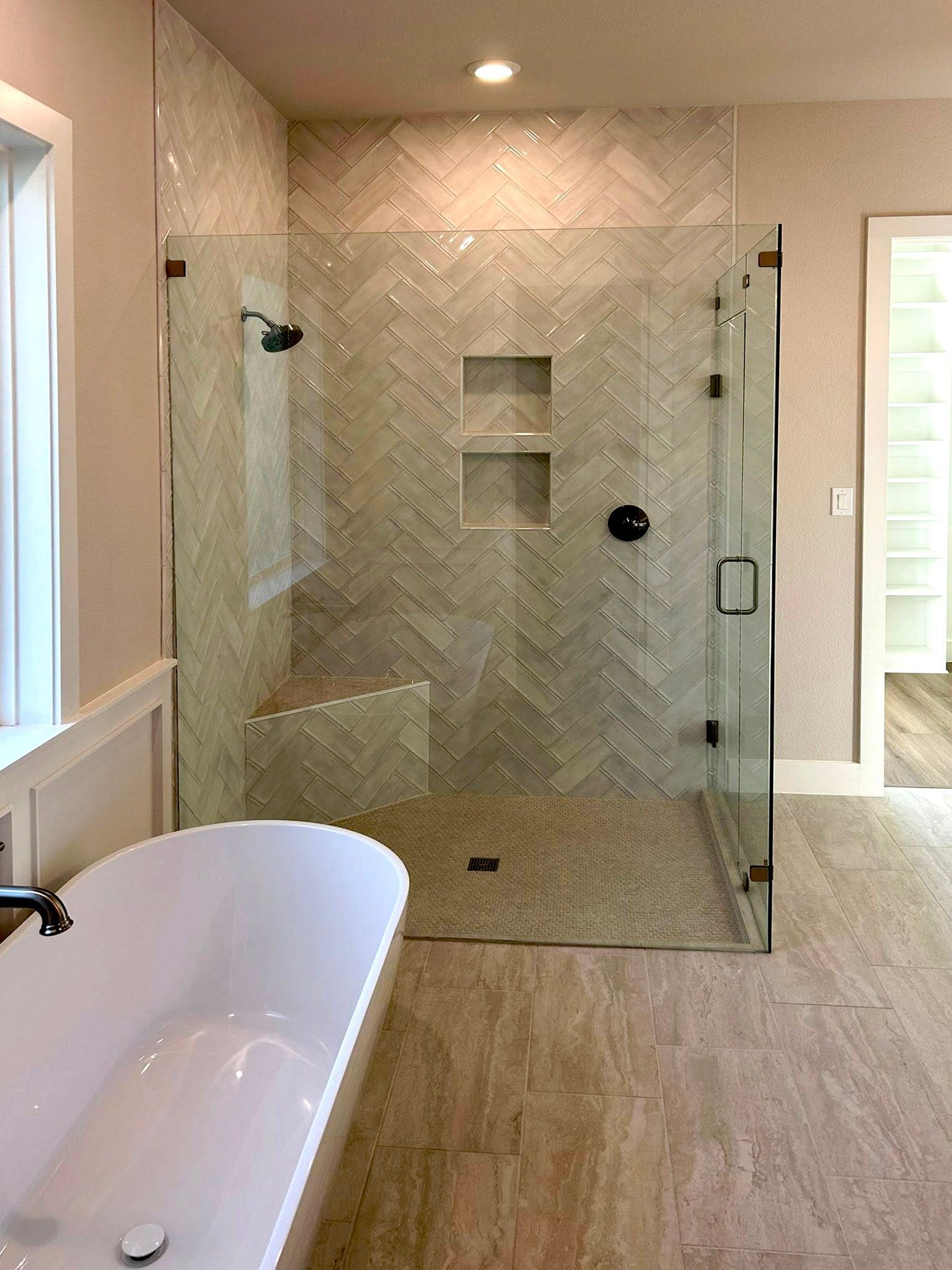 walk-in shower with tile backsplash and glass enclosure