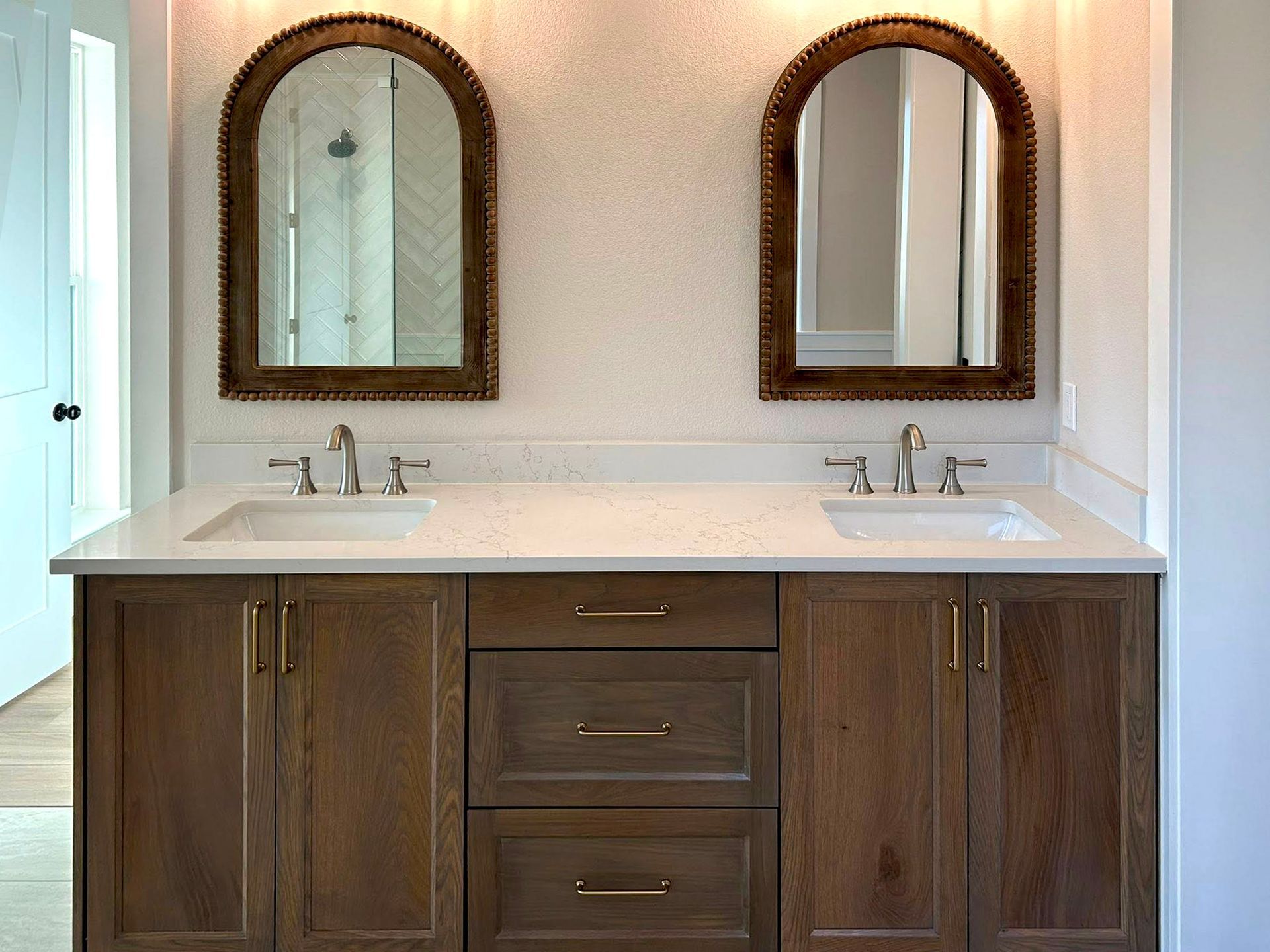 bathroom vanity with double sinks and framed mirrors