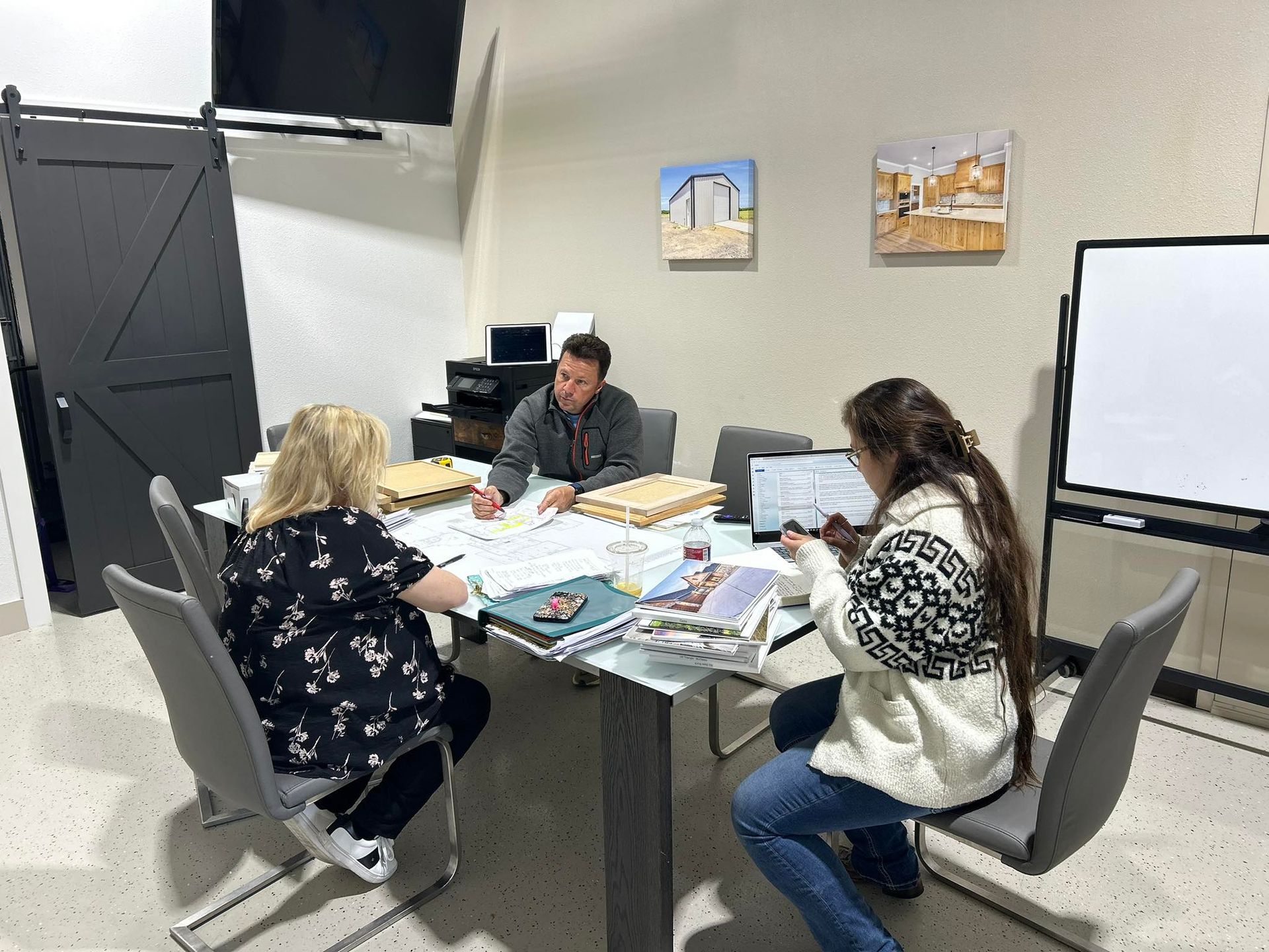 team meeting discussing custom home plans