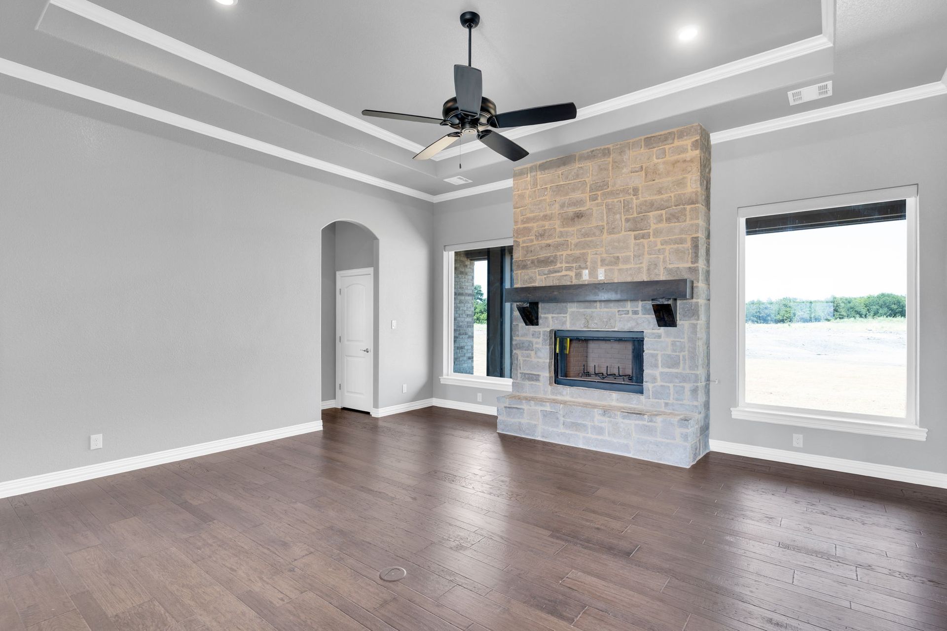 open living space with fireplace and large windows