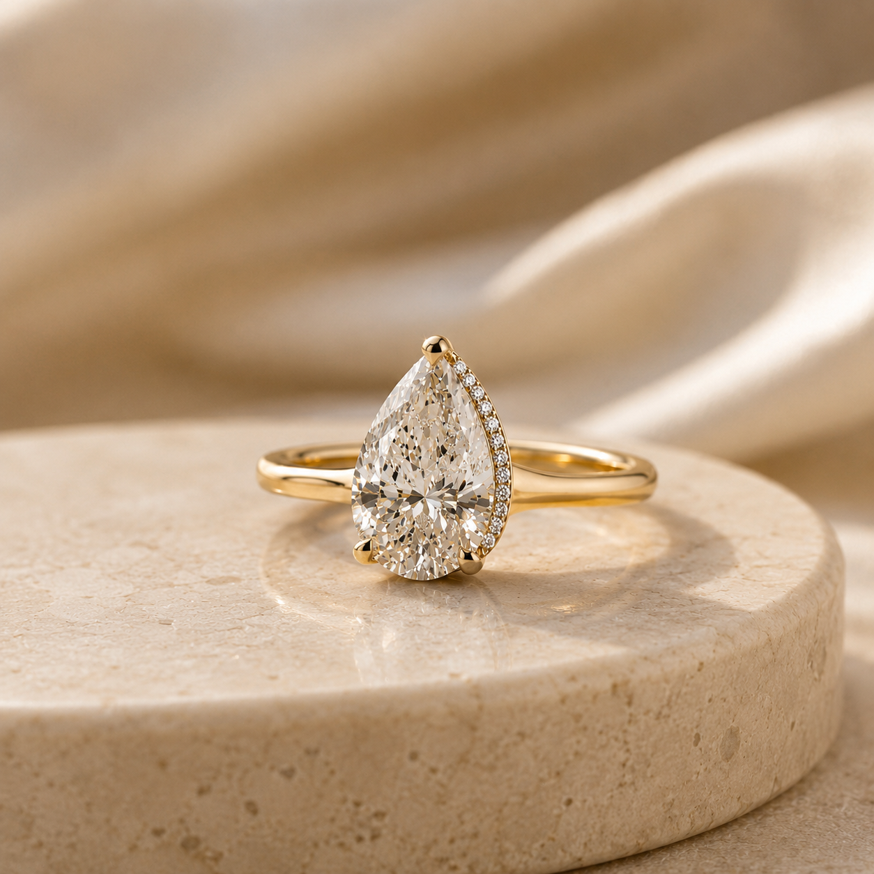 Two silver rings on a white lace background, one with a blue gemstone and dangling charm