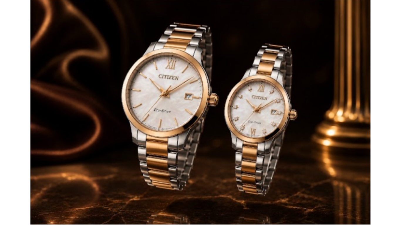 Gold Citizen wristwatch with white face and black leather strap on a dark wooden surface