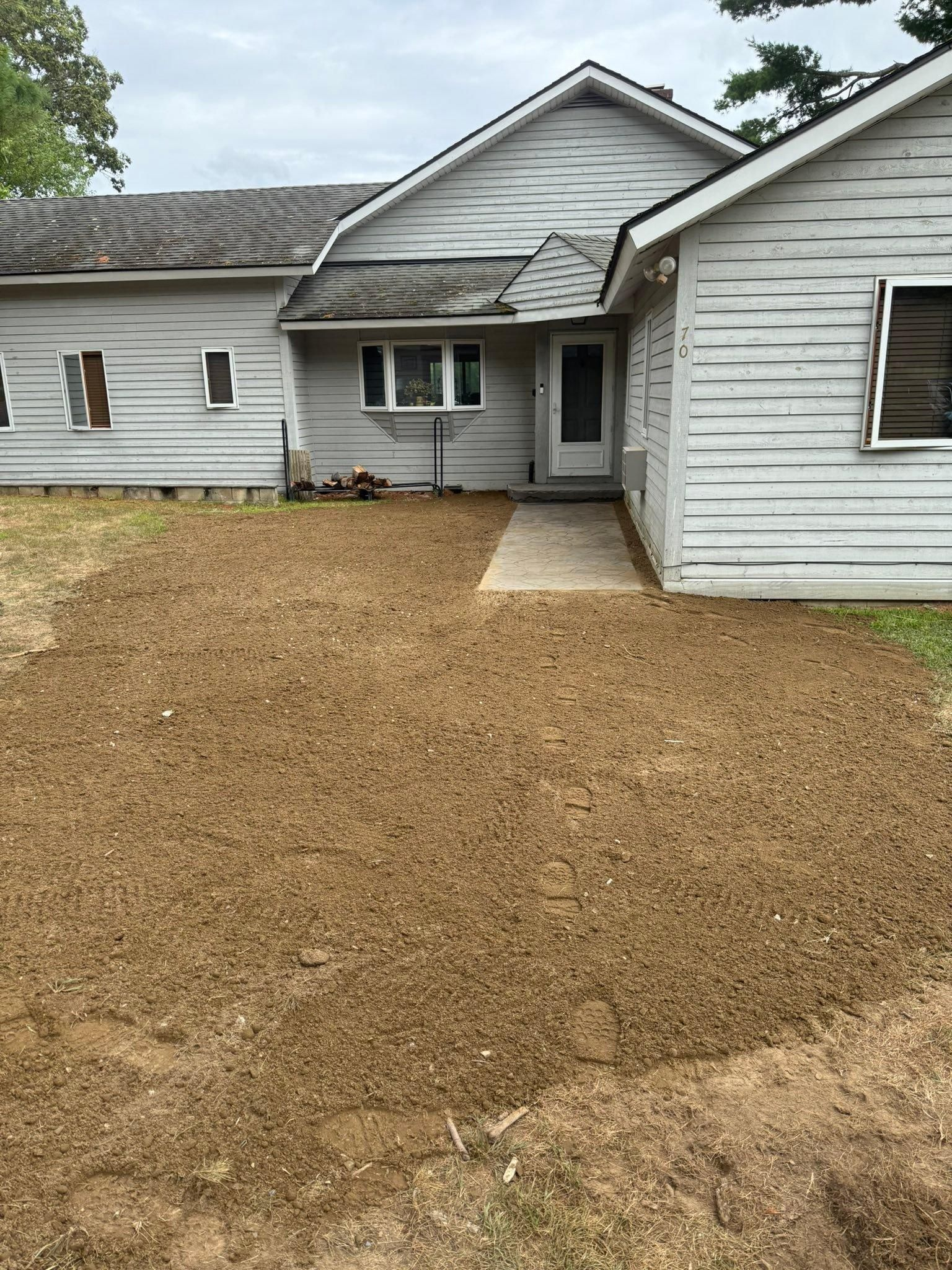 White house exterior with gravel yard and front porch entrance