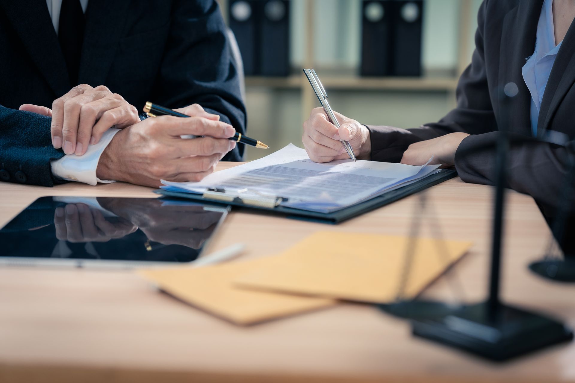 Trusts lawyer meeting with a client to review and sign trust documents.