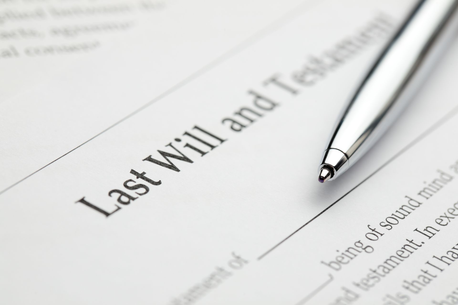Last will and testament document with a pen for estate planning.