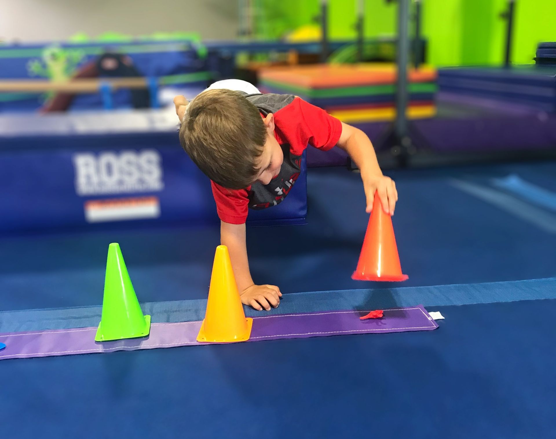 A group of children are playing a game in a gym.