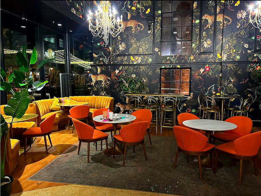 A restaurant with tables and chairs and a chandelier