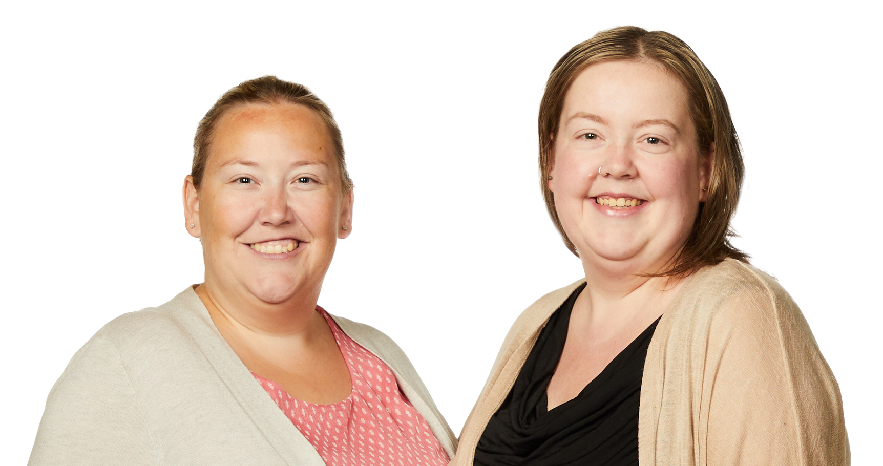 Two women are standing next to each other and smiling for the camera.