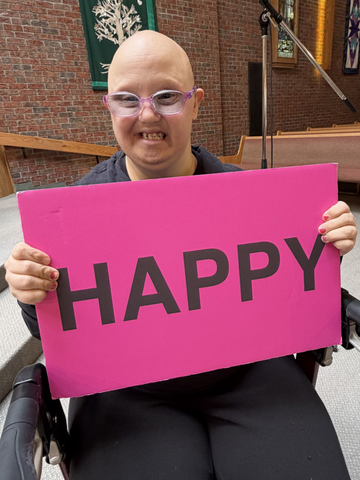 woman holding a happy sign
