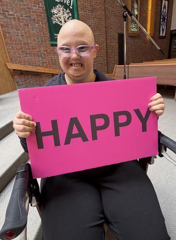 woman holding a happy sign