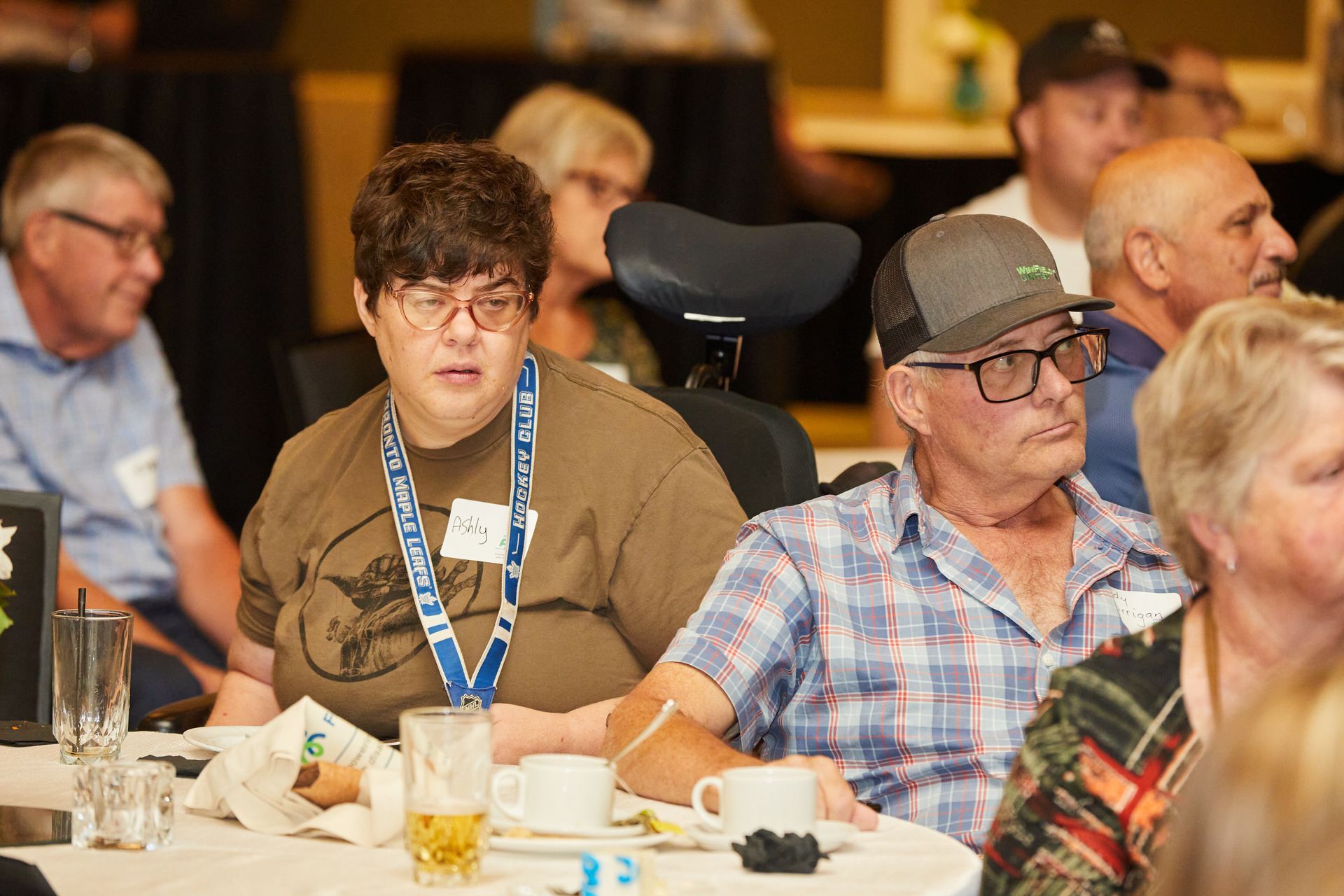 A group of people are sitting at tables in a room.