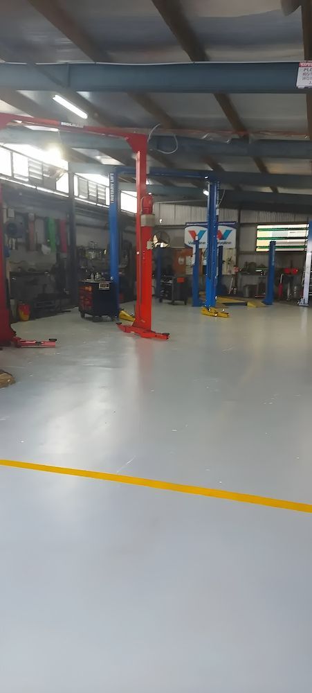 A Large Garage With A Lot Of Lifts In It — A & D Automotive Technicians in Mackay, QLD
