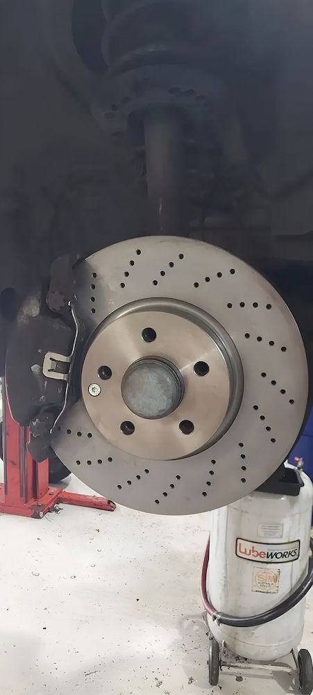 A Brake Disc On A Car On A Lift — A & D Automotive Technicians in Mackay, QLD