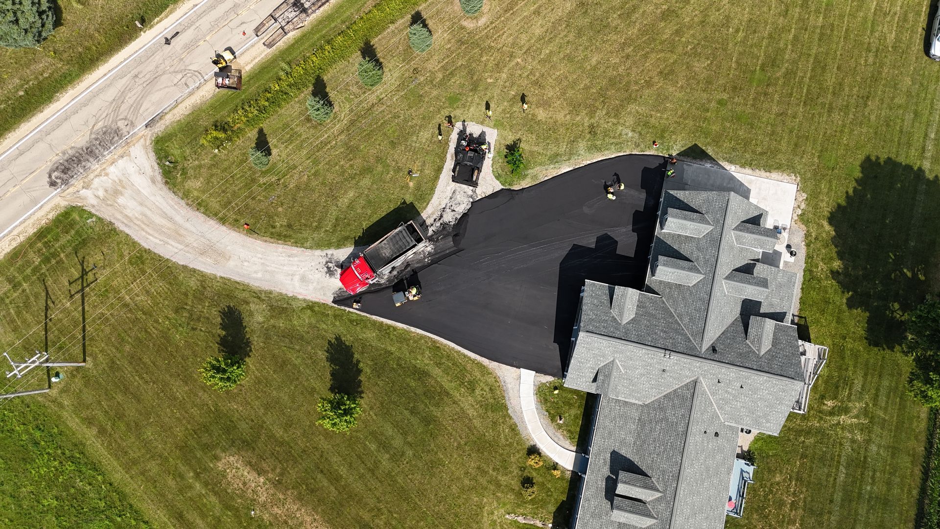 Aerial view of Black Earth Pavement crew paving a large residential driveway