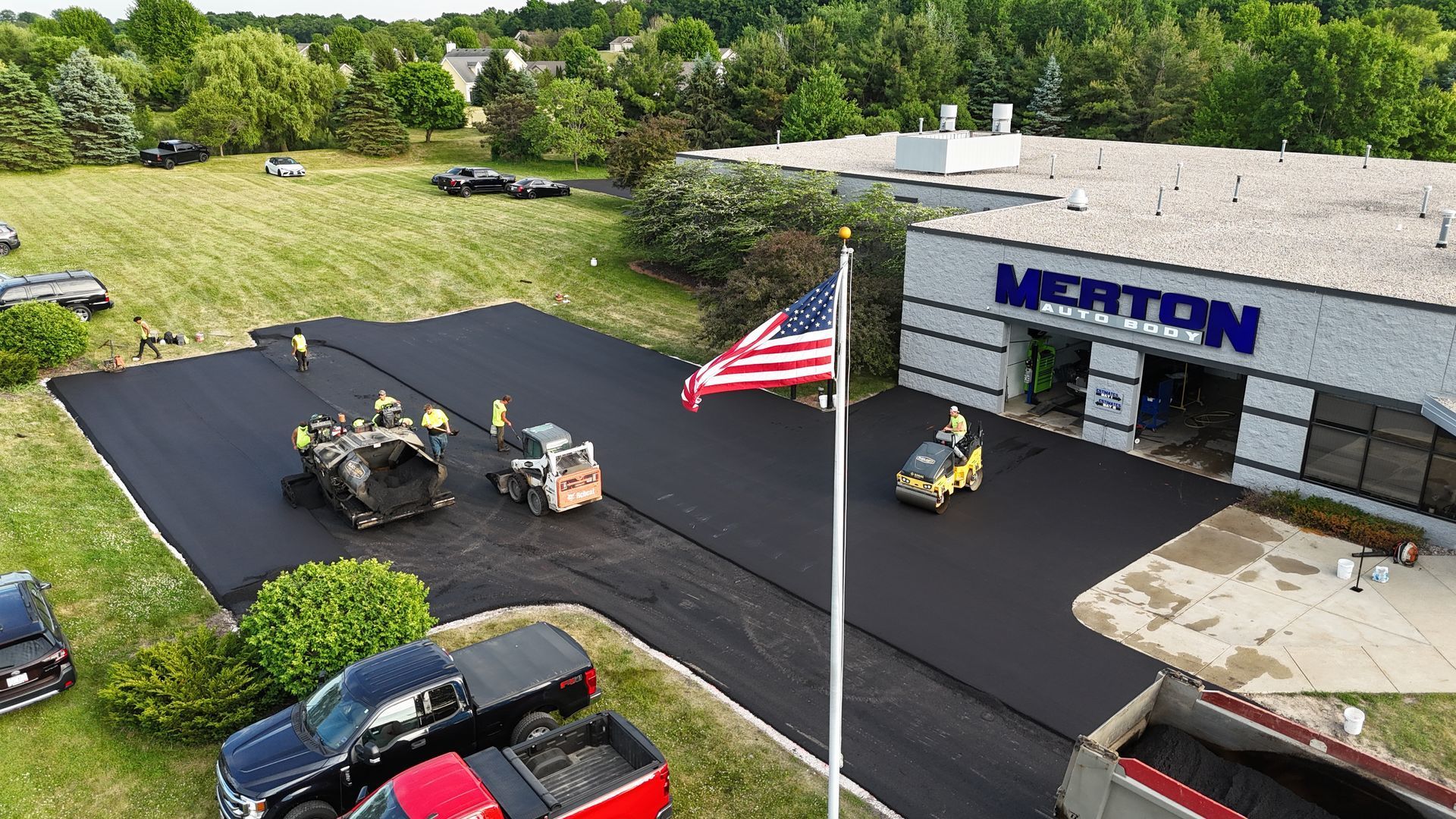 Black Earth Pavement crew paving a commercial parking lot at Merton Auto Body