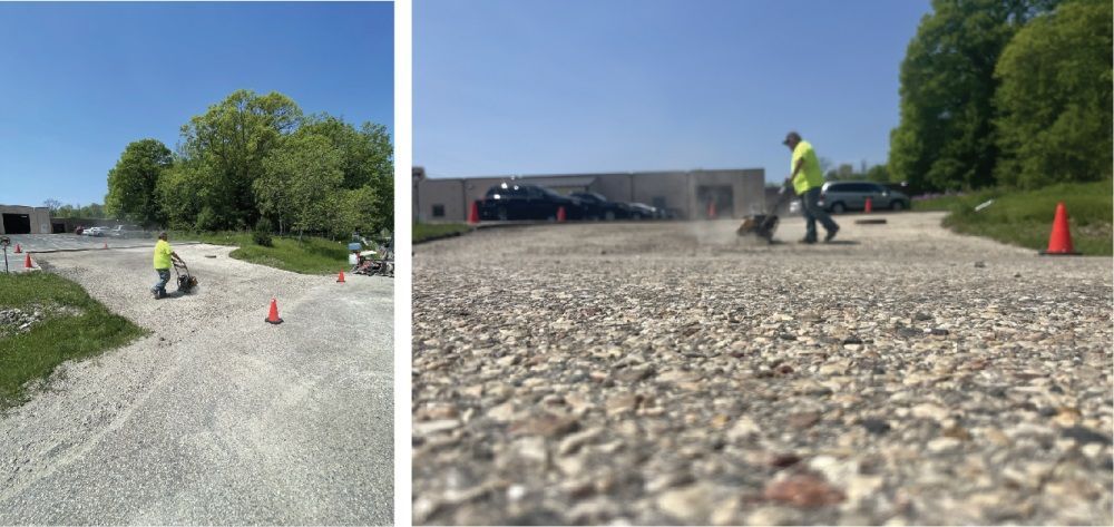Two construction workers operating compact rollers on freshly paved asphalt near an industrial building.