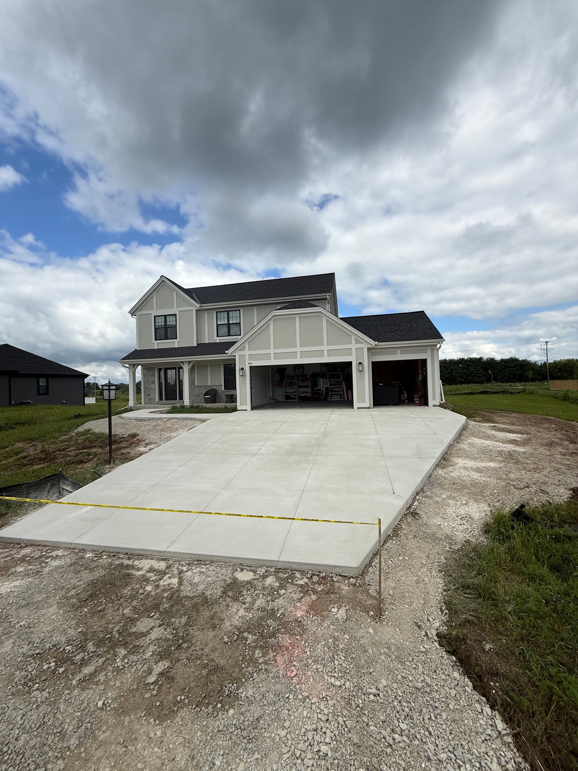 New concrete driveway installed in front of a residential home