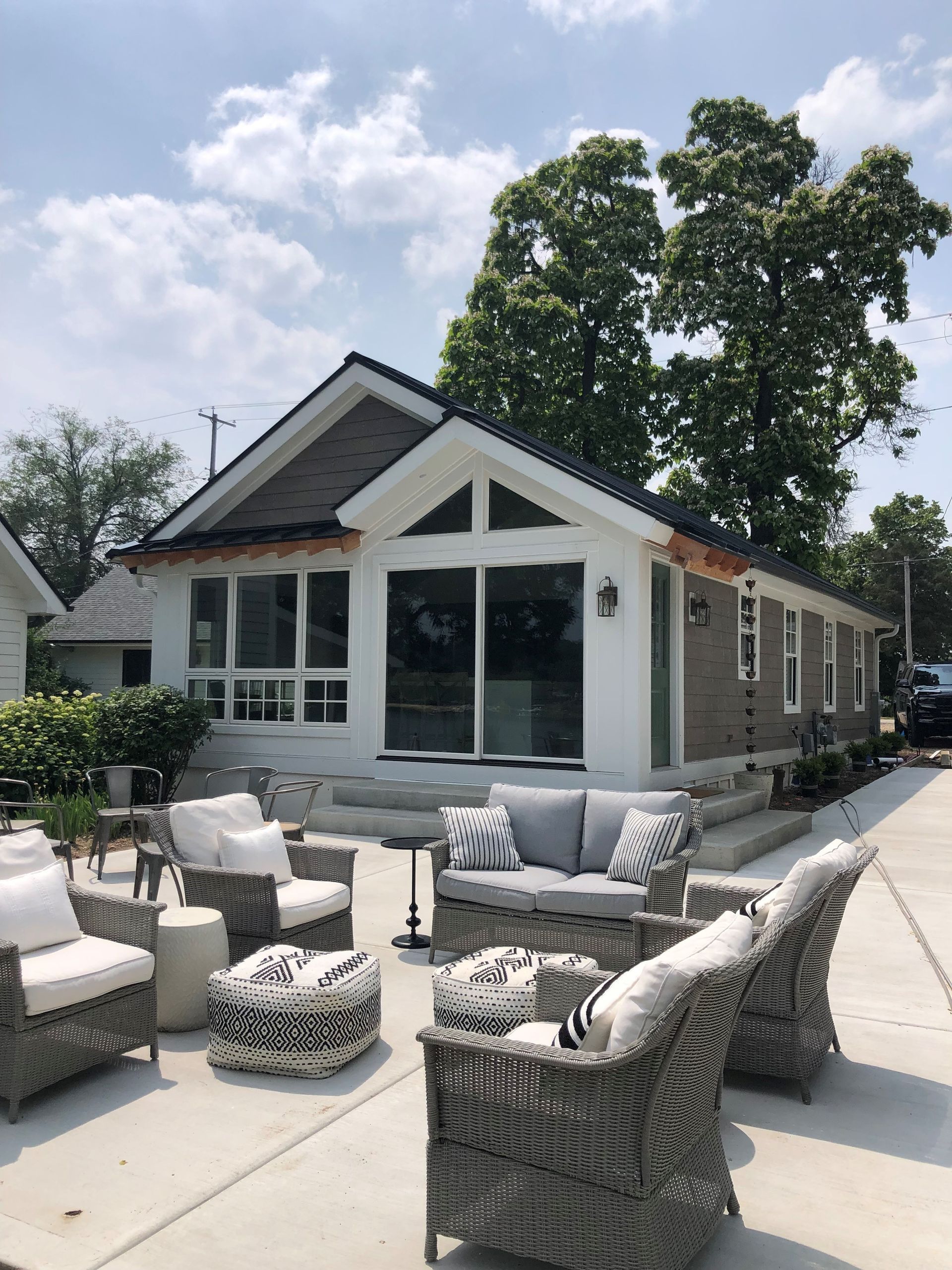 Finished concrete patio with outdoor seating beside a residential home