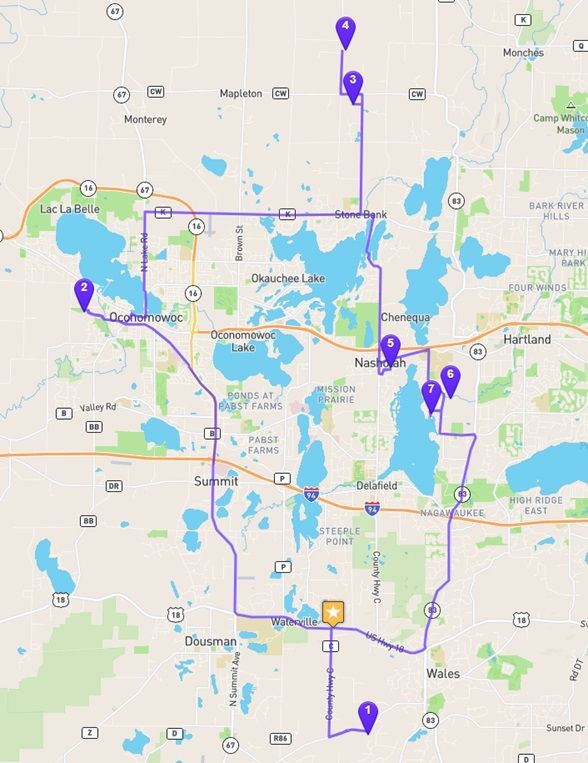 Map with a purple route and several location pins across a city.