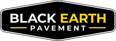 Black and gold Black Earth Pavement logo on a black sign shape