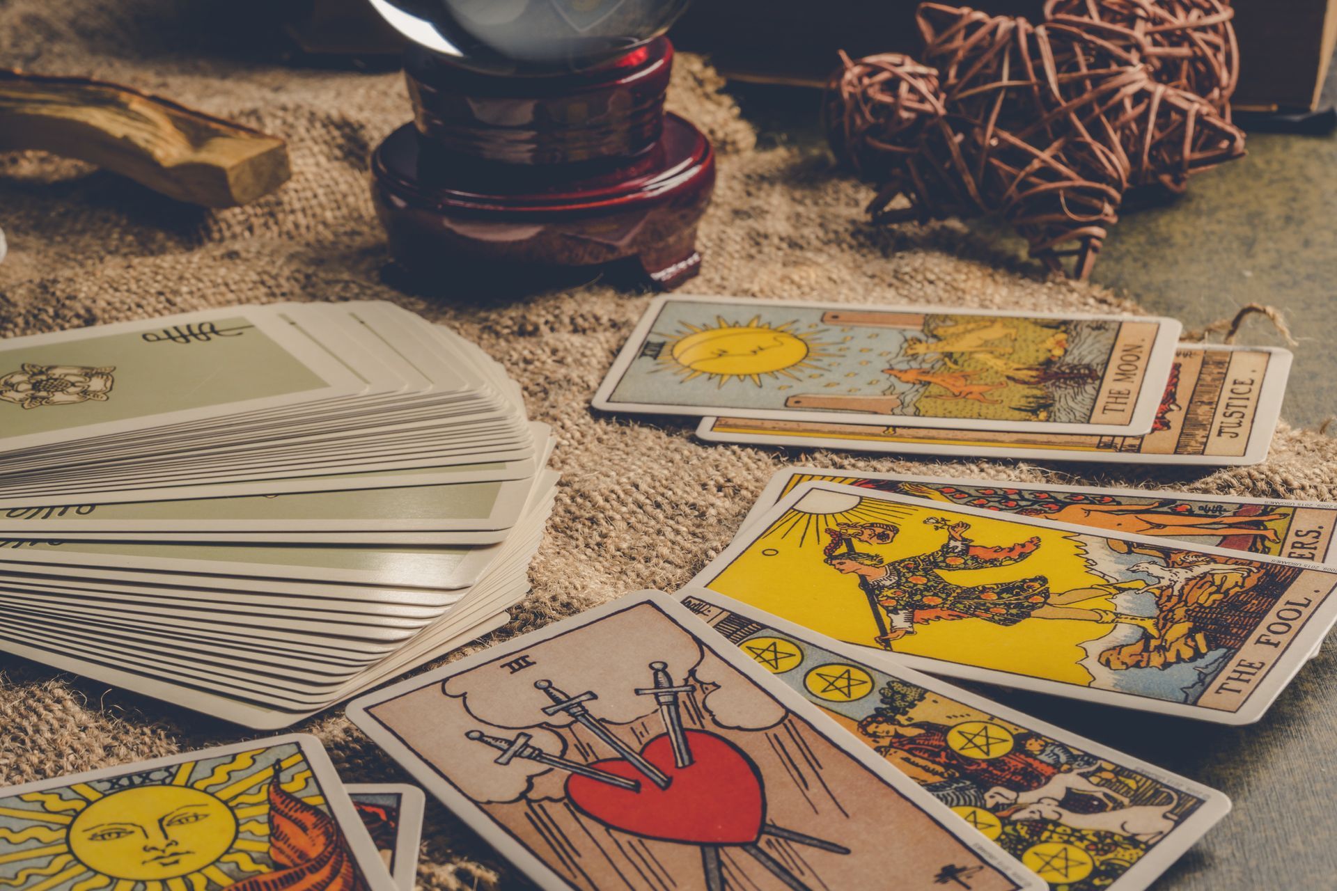 A mix of tarot cards piled on a table