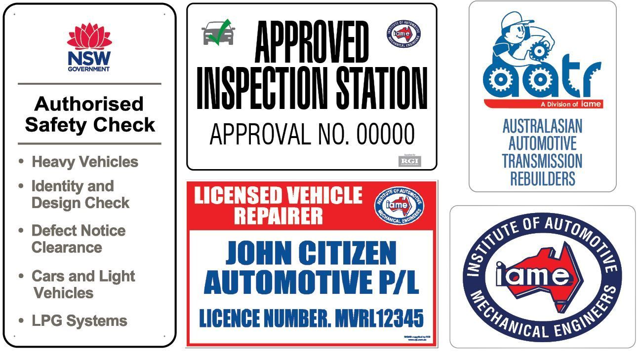 Various automotive service signs: safety check, inspection station, vehicle repairer, transmission rebuilders, and mechanical engineers.