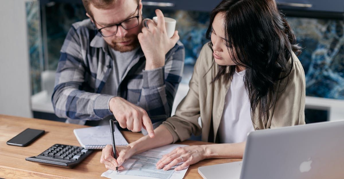 Man and Woman Completing Debt Restructuring Forms