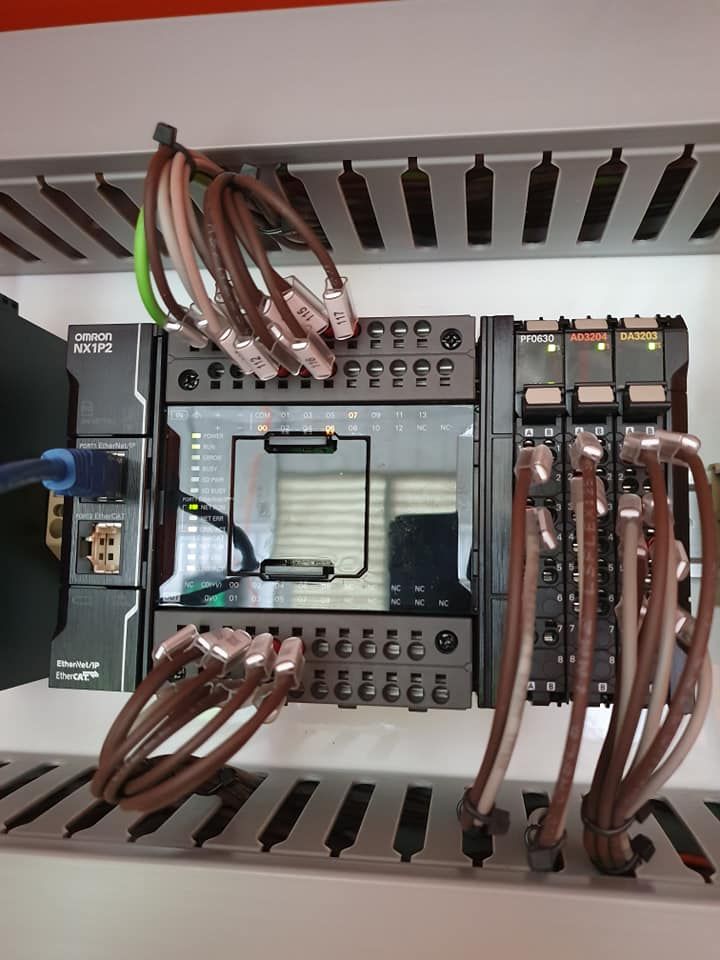 Electrical control panel with wires, terminals, and relays inside an open enclosure