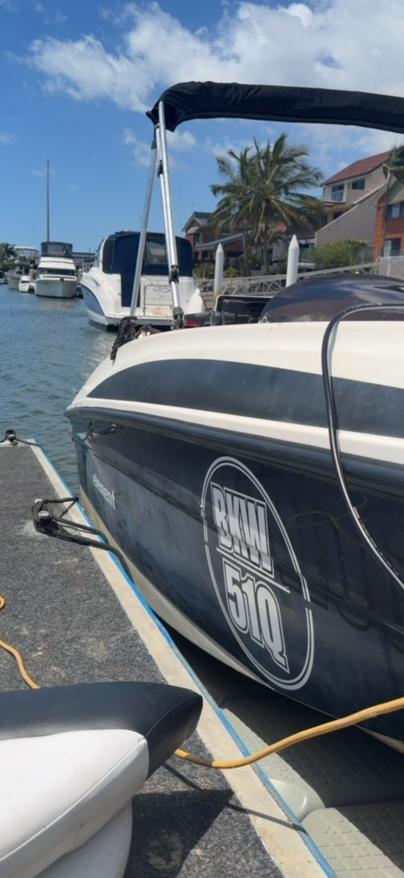 A dark blue and white powerboat, marked with 