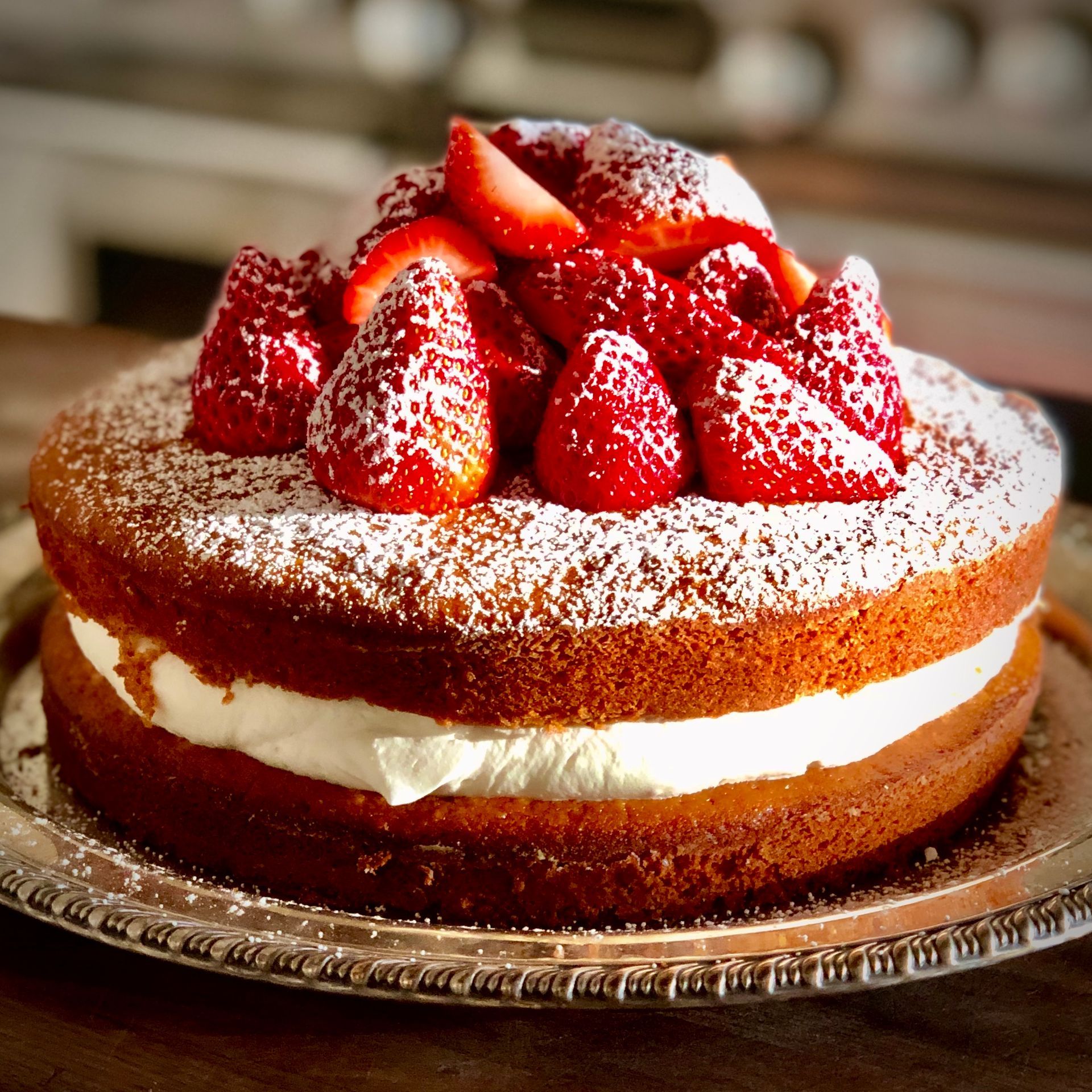 Strawberry cake with cream filling, powdered sugar